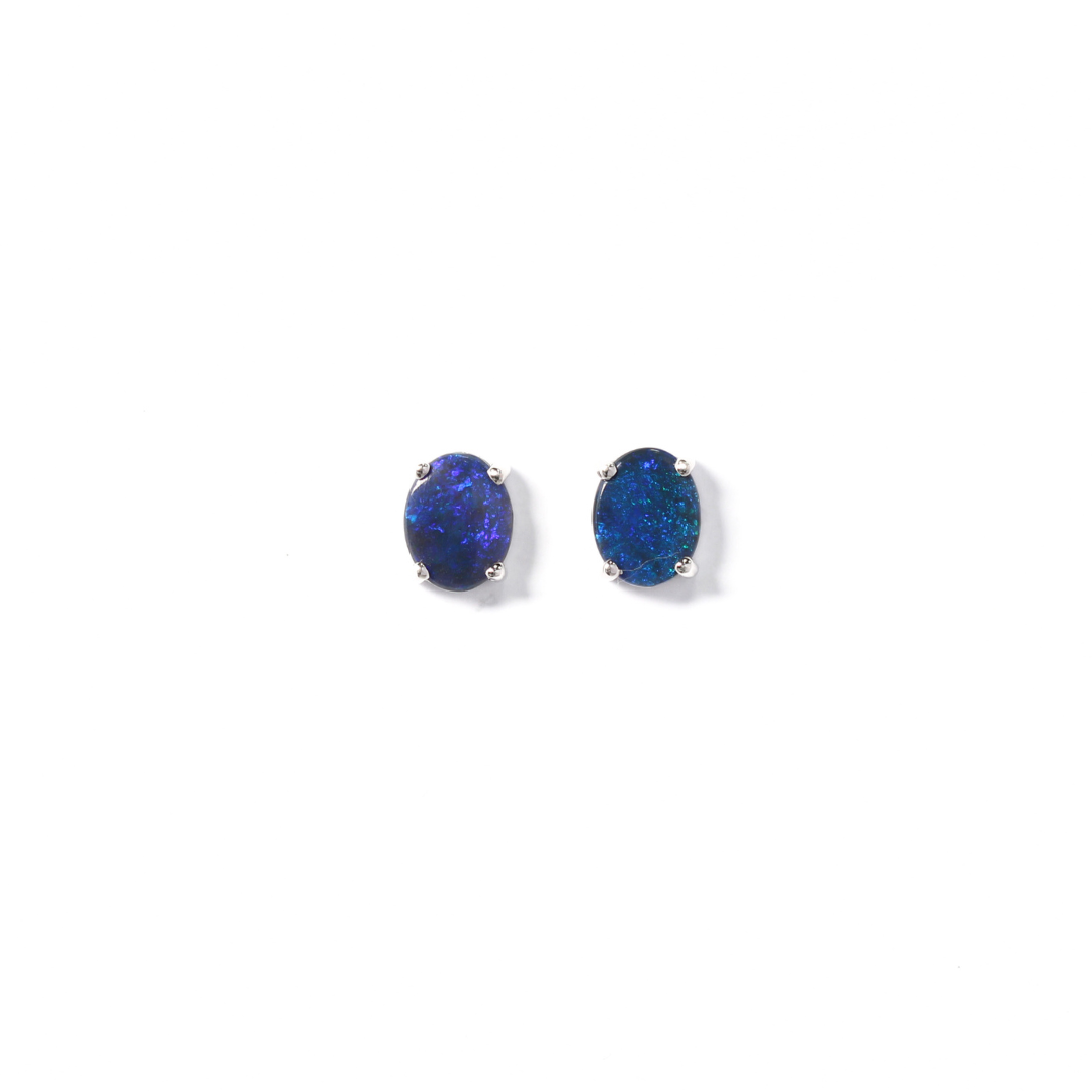 Deep blue coloured oval shaped opal earrings set in white gold