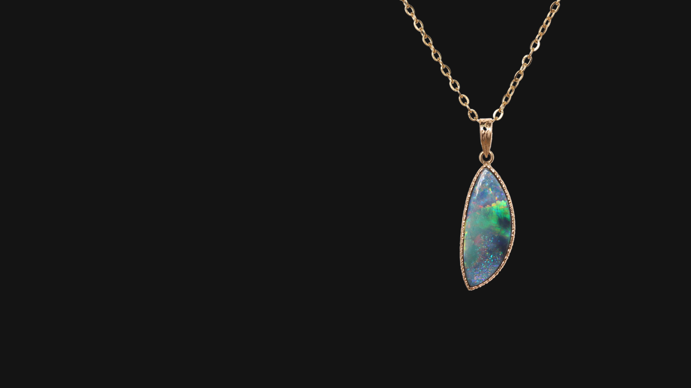 Black opal pendant with green, blue and red colours in a gold setting