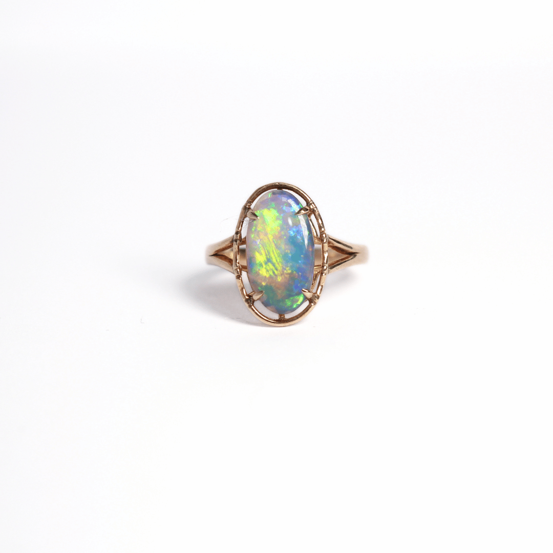 Black opal ring with vivid colours of yellow, green and blue